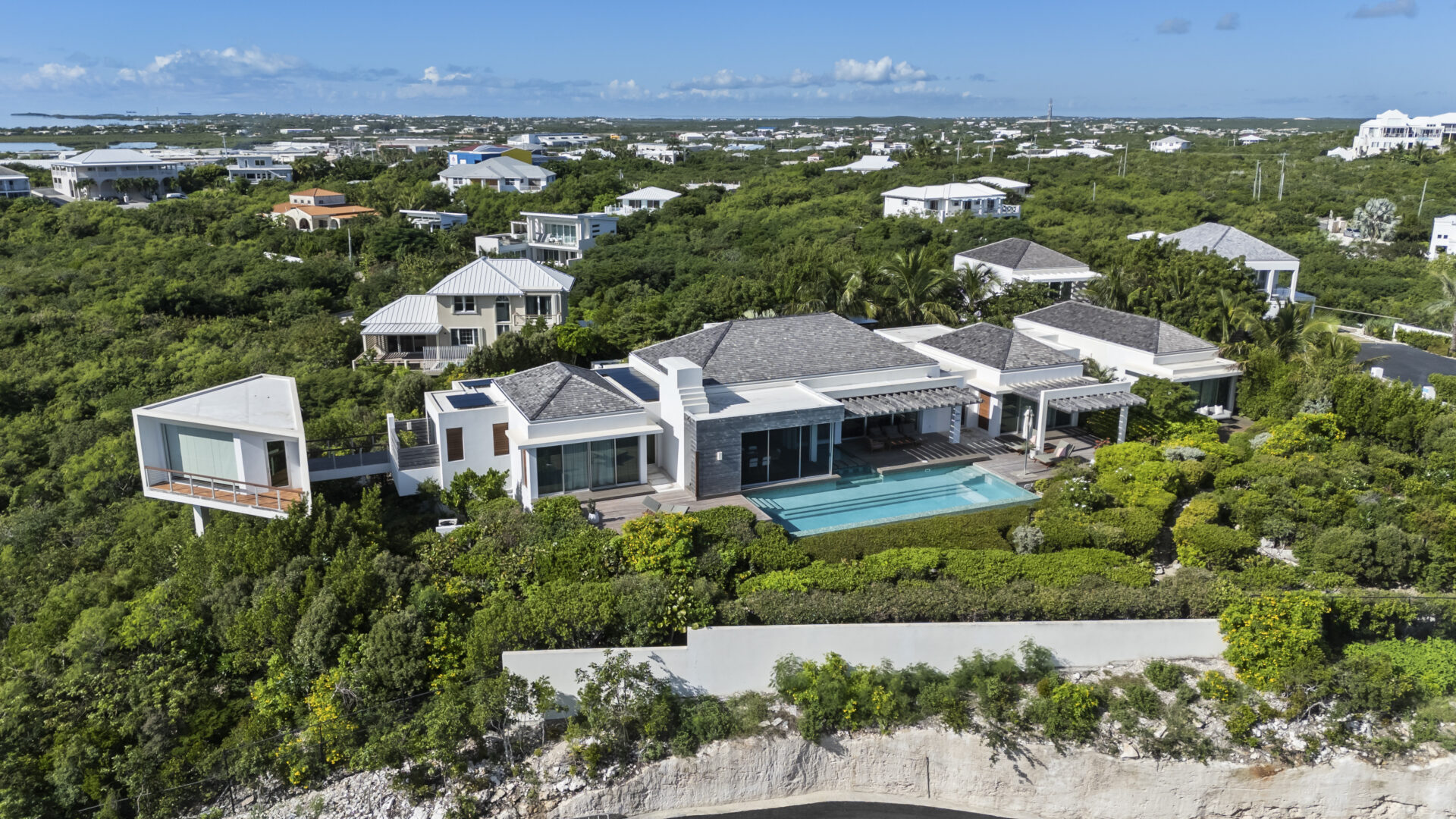 Aerial view of a modern luxury villa with private pool in Providenciales